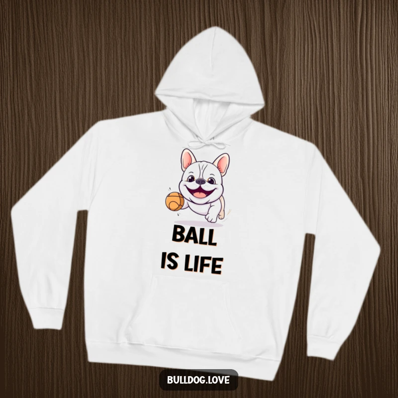 Funny kawaii bulldog hoodie showing a smiling dog about to catch a bouncing ball, embodying playful spirit and cozy comfort.